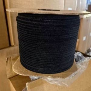Black brush weatherstrip wound on a bulk reel beside cardboard cartons