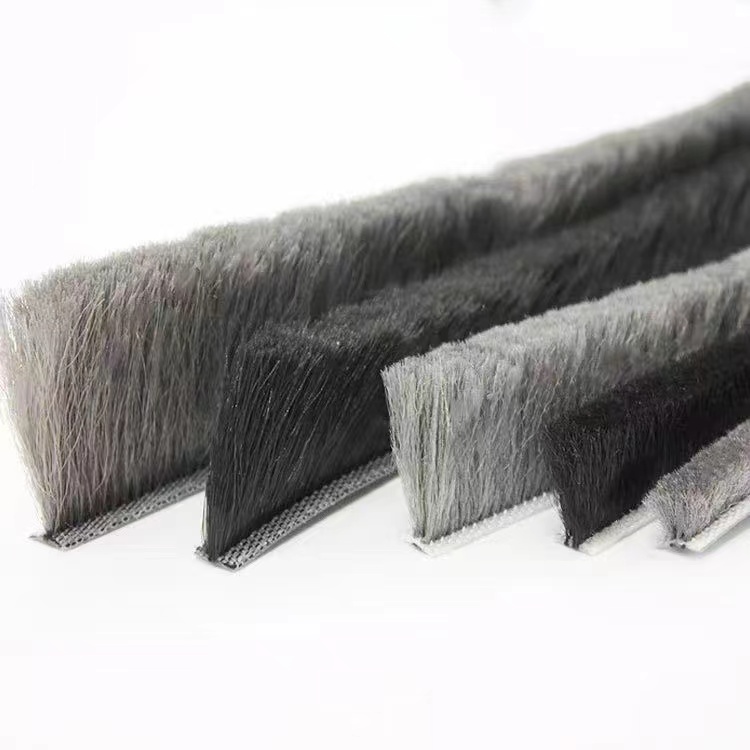 Grey and black brush seal strips with different pile heights on narrow backing strips
