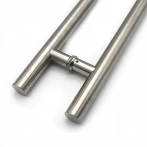 Close-up of a brushed round-tube glass door pull showing the mounting collar and fixing screw