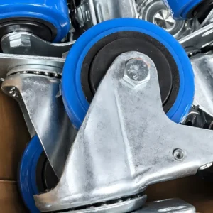Blue TPR brake casters packed together, showing wheel hubs and metal top plates